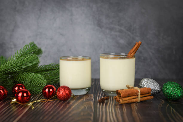 istock Eggnog delicious holiday drinks like themed parties with cinnamon pine cone and red ball for Traditional Christmas and winter holidays Homemade eggnog in glasses pine branch decorated 1179753826