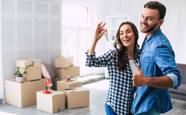 New home new life. A lovely couple feels very ecstatic about their recent purchase of a new home which makes them feel being on the verge of happiness. stock photo