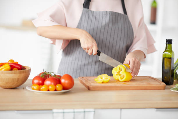 istock Woman cutting vegetables for salad 1179754513