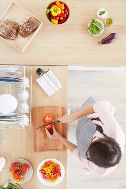 istock Woman cutting vegetables 1179756218