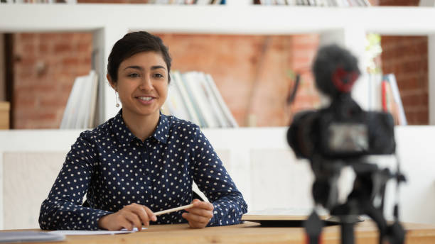 Happy indian girl recording self-introduction or educational video.