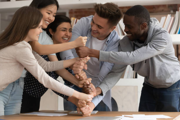 istock Overjoyed mixed race young students involved in teambuilding activity. 1179756361