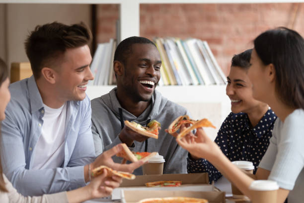 istock Group of diverse students ordered delivery fast food in campus. 1179756363