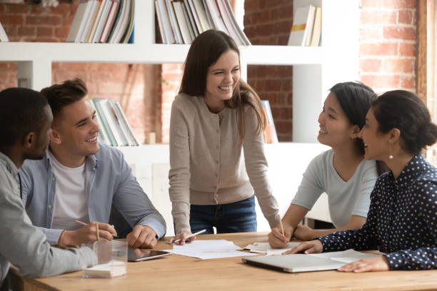 istock Happy young girl team leader having fun with diverse mates. 1179756364