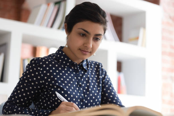 istock Close up concentrated indian female student preparing for exams. 1179756400