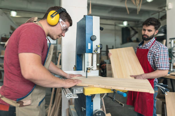 istock Professional carpenter cutting wooden board 1179757082
