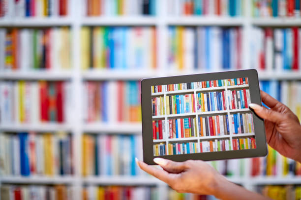 Female hand holding tablet computer including books shelves image