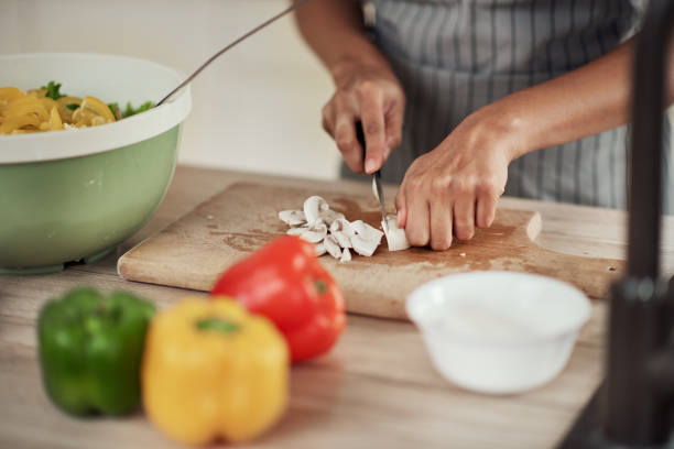 istock Woman chopping mushrooms. 1179757357