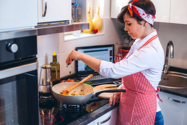 istock Young woman preparing a meal 1179757483