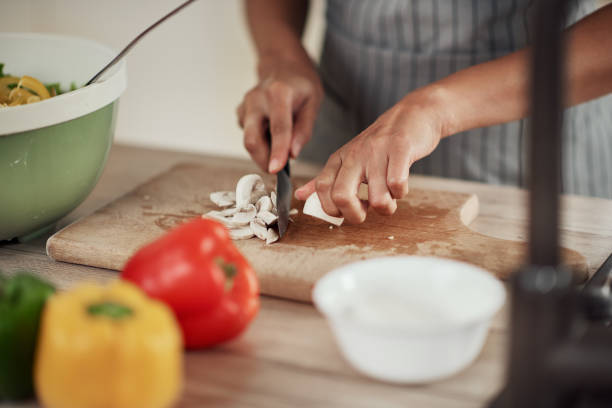 istock Woman chopping mushrooms. 1179757498