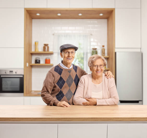 istock Elderly man and woman standing in a kitchen 1179757629