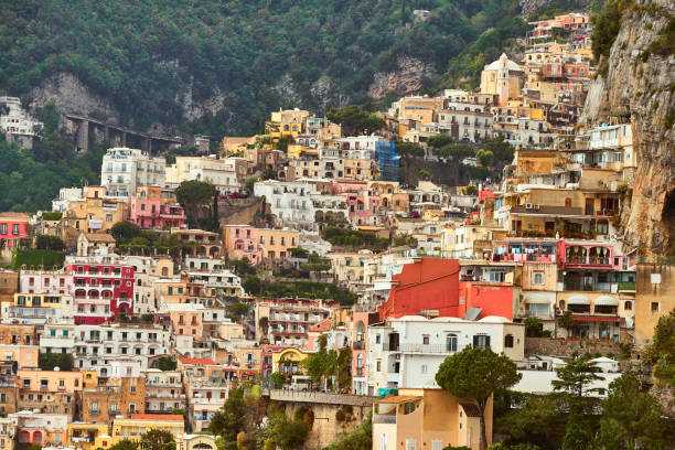Looking at the famous village of Positano on the Amalfi coast. Many of the small villages along the Amalfi coastline are hundreds of meters above sea level, because of the geographical reasons. The Amalfi coast is a stretch of coastline on the northern coast of the Salerno Gulf on the Tyrrhenian Sea, located in the Province of Salerno of southern Italy. The Amalfi Coast is a popular tourist destination for the region and Italy as a whole, attracting thousands of tourists annually. In 1997, the Amalfi Coast was listed as a UNESCO World Heritage Site.