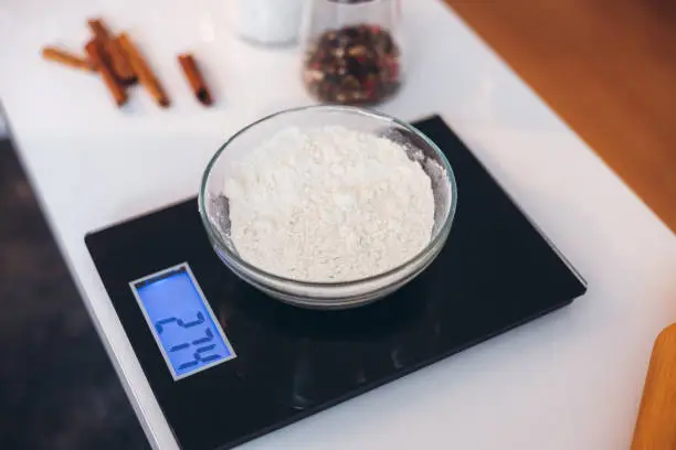 Bowl with flour on kitchen scale.