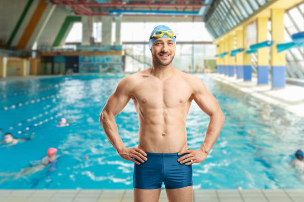 istock Male swimmer with cap and goggles at a swimming pool 1179757729