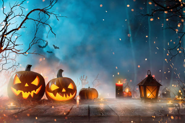 istock Halloween pumpkins on dark spooky forest. 1179758563