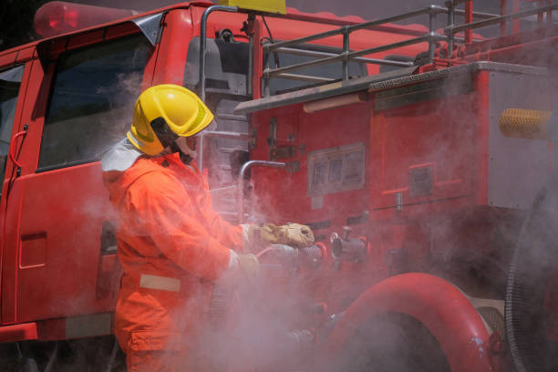 istock Firefighters training, Team practice to fighting with fire in emergency situation. A fireman attach hose to fire fighter vehicle 1179758594