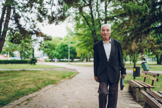 istock Senior man walking in a park 1179758750