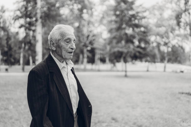 istock Senior man walking in a park 1179758755
