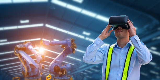 Businessman using VR Glasses for virtual reality and robot welding machines Businessman using VR Glasses for virtual reality and robot welding machines, automatic mechanical arms, modern industrial factories.Industry 4.0 af_istocker stock pictures, royalty-free photos & images