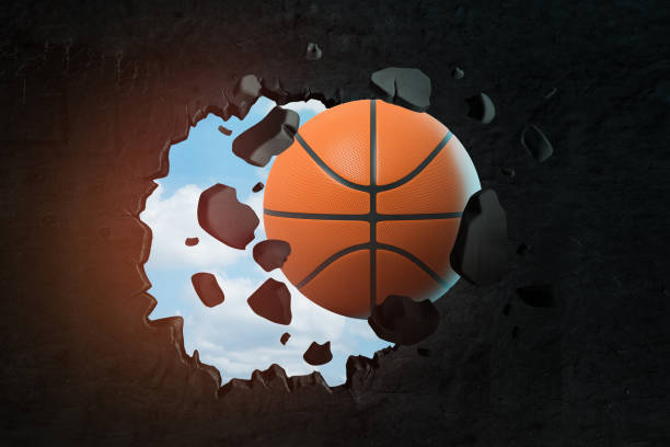 istock 3d rendering of orange basketball ball breaking black wall 1179759710