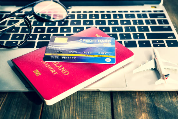 istock Passport and h  credit card on laptop 1179759723