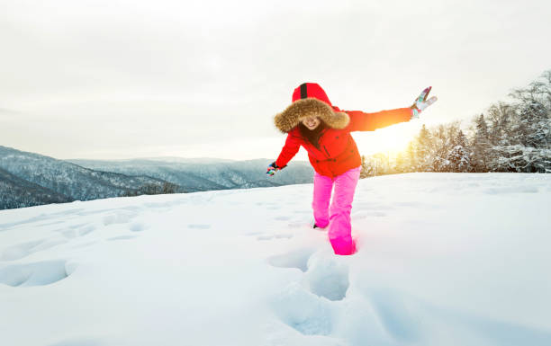 Woman walking through the deep snow.