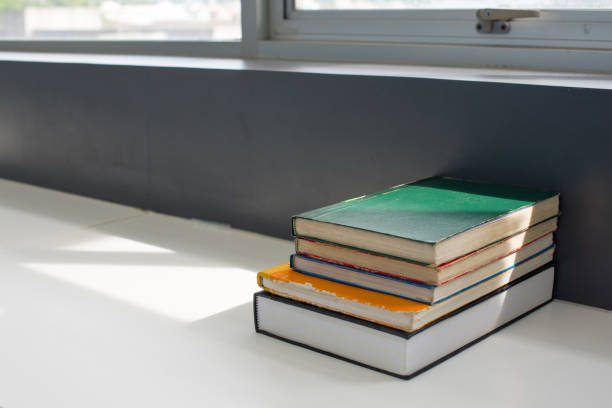 istock books stacked on the table at the university library in selective focus. 1179761182