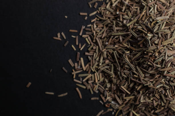 istock Spice caraway seeds sprinkled on a black background 1179761356