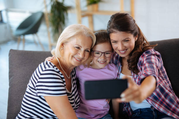 istock Three generations of happy women taking selfie 1179761571