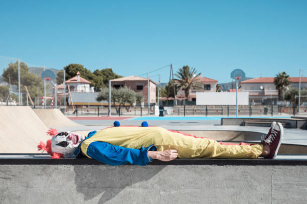 istock scary clown lying down outdoors 1179761661
