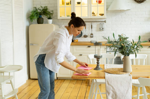 istock Young woman cleaning dust at the kitchen 1179762395