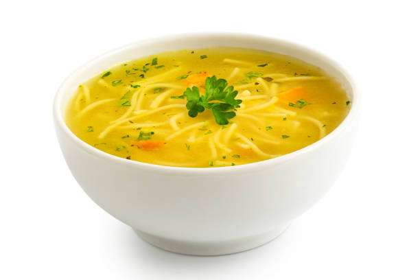 istock Instant chicken noodle soup in a white ceramic bowl isolated on white. Parsley garnish. 1179762418