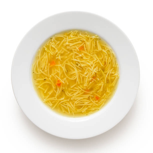 istock Instant chicken noodle soup in a white ceramic soup plate isolated on white. Top view. 1179762470
