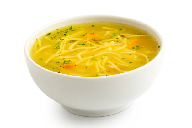 istock Instant chicken noodle soup in a white ceramic bowl isolated on white. 1179762532