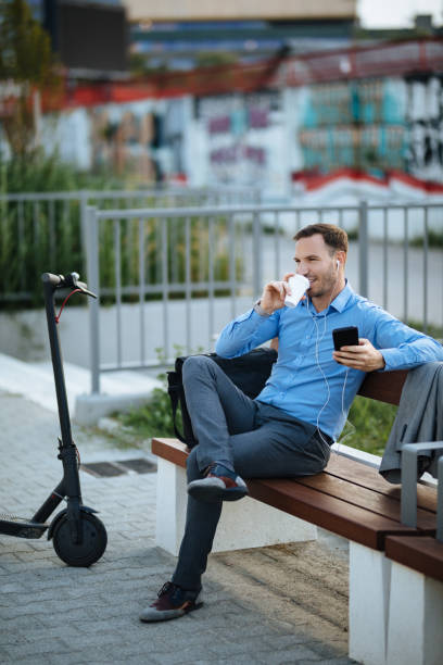 istock Businessman with electric push scooter using mobile phone 1179762809