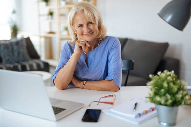 istock Senior woman using laptop at home 1179762939