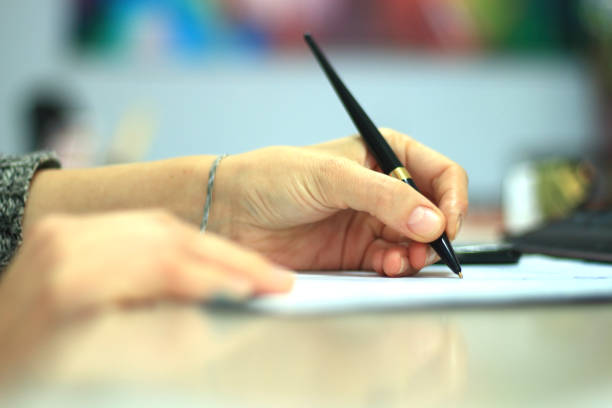 istock Businesswoman writing to notepad in office 1179763075