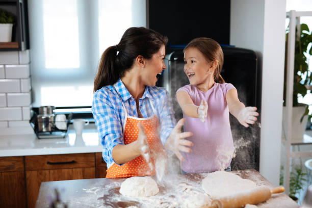 istock Happy family in the kitchen making cookies 1179763088