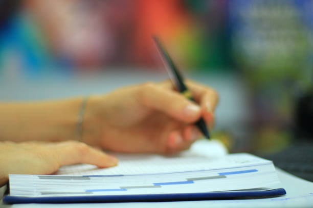 istock Businesswoman writing to notepad in office 1179763106