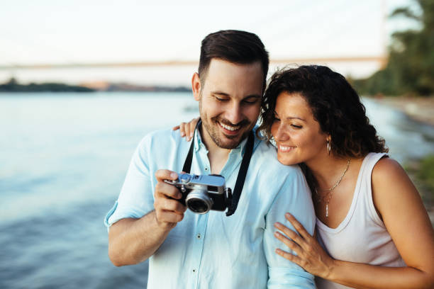 istock Couple in love looking at photos on camera 1179763336