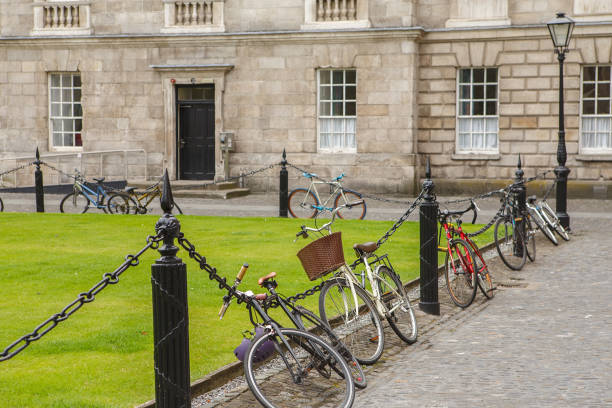 Bicycle parking at Courtyard Trinity College in Dublin, Ireland. Trinity college campus. Bicycle parking at Courtyard Trinity College in Dublin, Ireland. Trinity college campus. trinity college library stock pictures, royalty-free photos & images