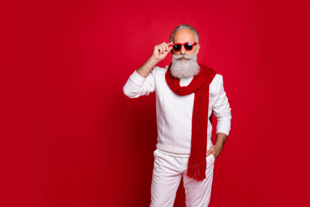 istock Portrait of his he nice attractive handsome virile content chic classy gray-haired man wearing pullover sweater touching specs wintertime appearance isolated over bright vivid shine red background 1179764446