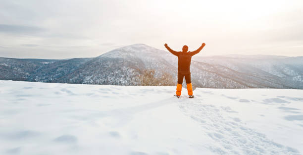 istock Man hiker on mountain top in winter 1179765824