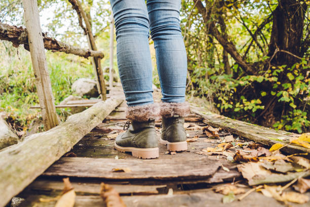 istock Female feet on mountain bridge 1179766161