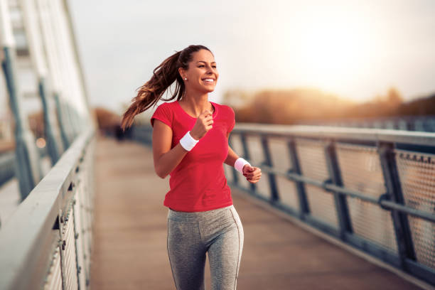 Fitness women exercising outdoors Beautiful fit woman in good shape jogging alone on city bridge. woman lifestyle stock pictures, royalty-free photos & images
