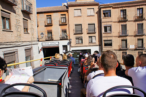 A tourist's point of view on the tour bus in the historic streets of Toledo, Castile and La Mancha, Spain - October 02, 2019