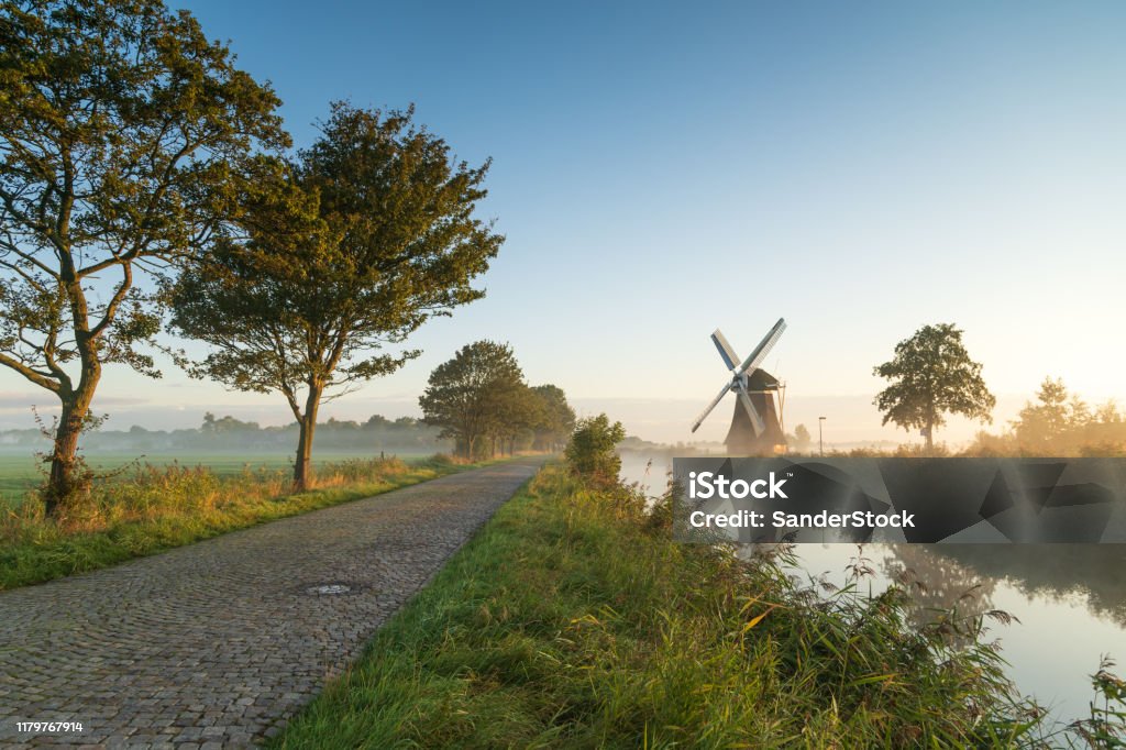 Rural Holland Windmill during a foggy, autumn sunrise in the Dutch countryside. Krimstermolen, Zuidwolde. Netherlands Stock Photo