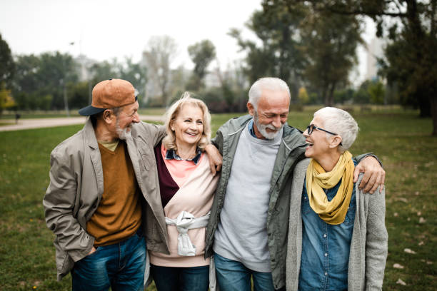 istock Happy seniors talking while walking embraced in nature. 1179768605