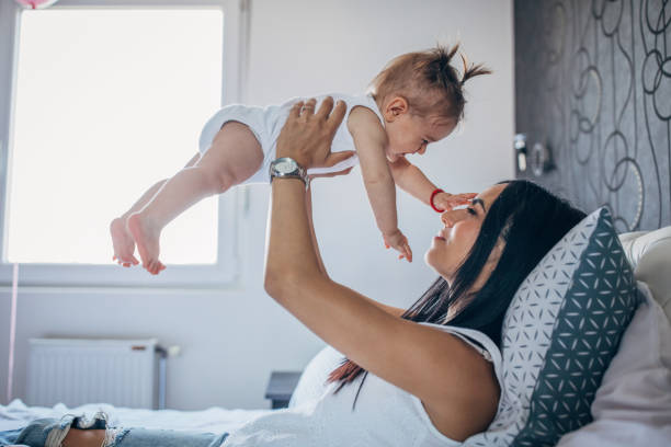 istock Young mom holding a baby in arms 1179768674