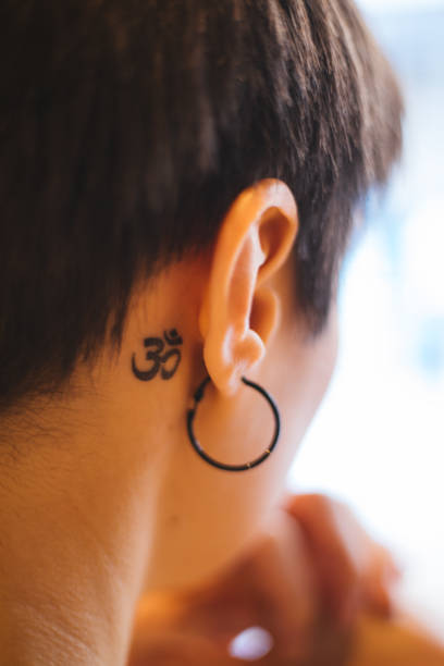 istock Woman with ohm tattoo 1179768984